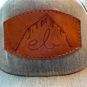 eb gray and black with leather trucker hat.